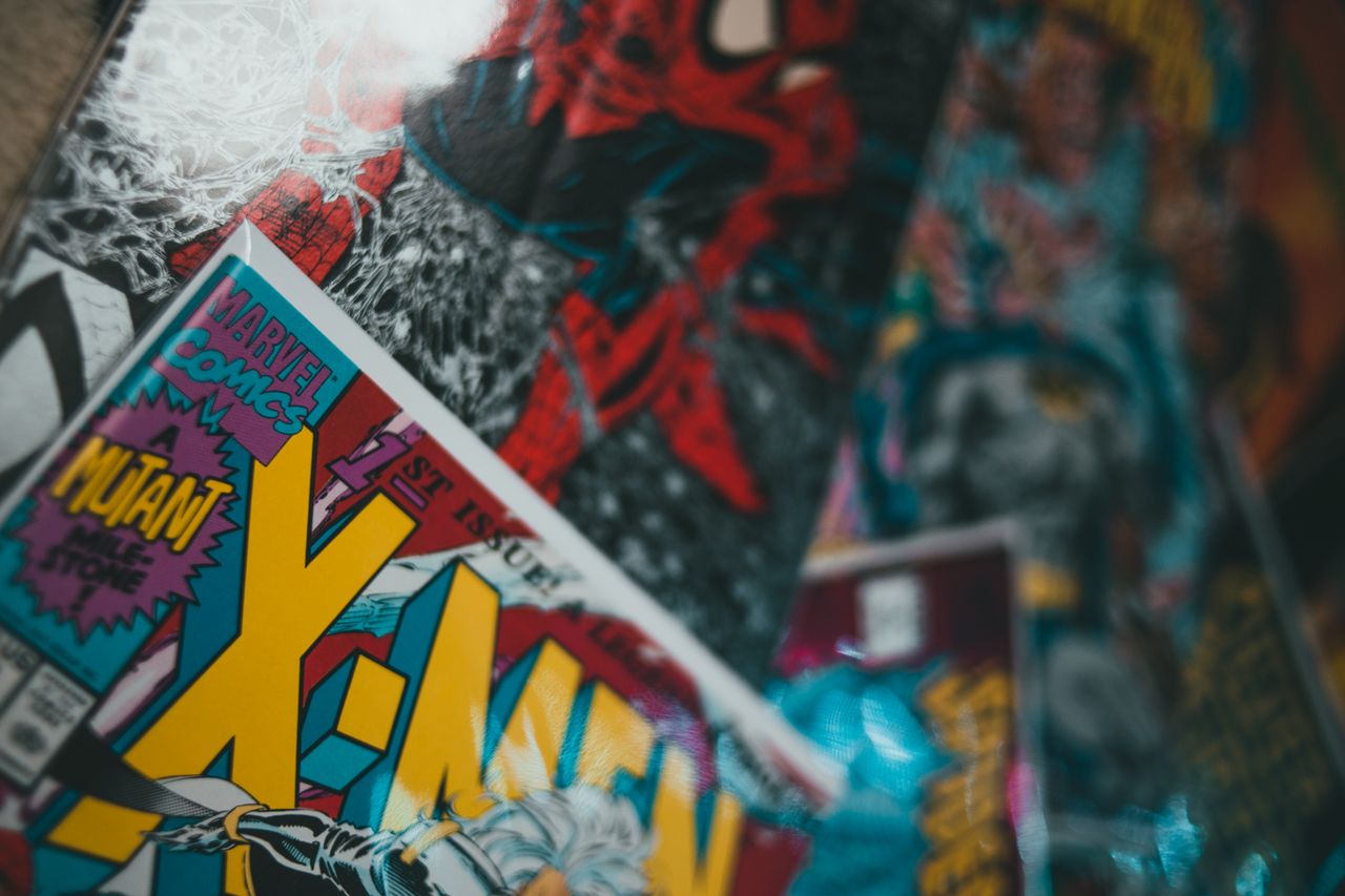 Mastering the First Impression: Your intriguing post title goes here From above closeup of collection of various comic books with colorful covers spread out on surface